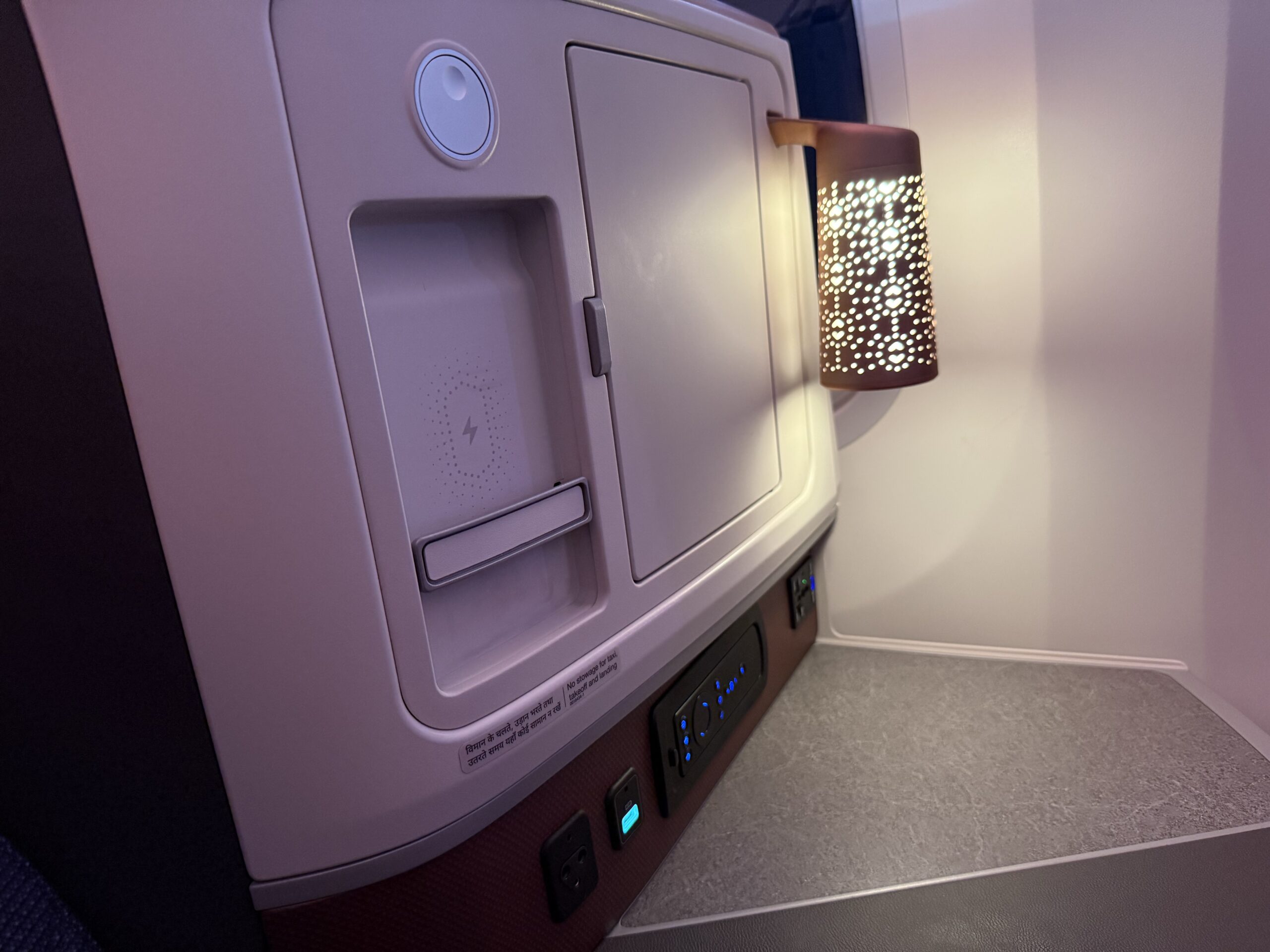 Air India 787-9 Business Class a white rectangular object with a light on it