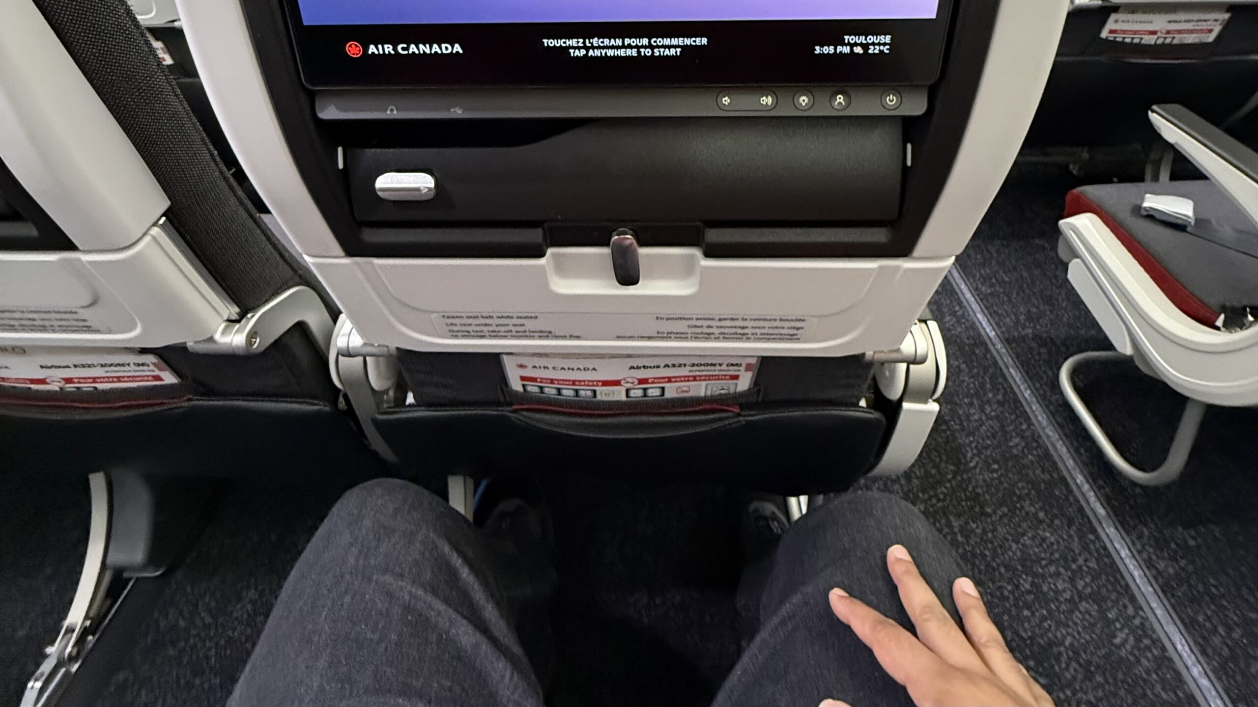 a person's hand on a seat