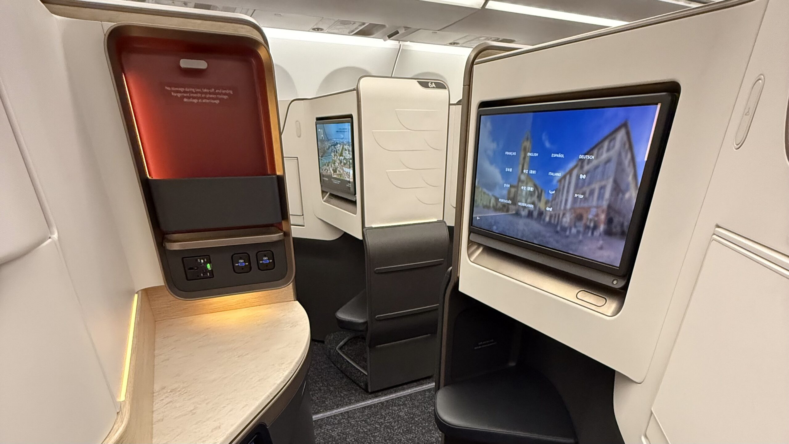 a tvs on the seats of an airplane