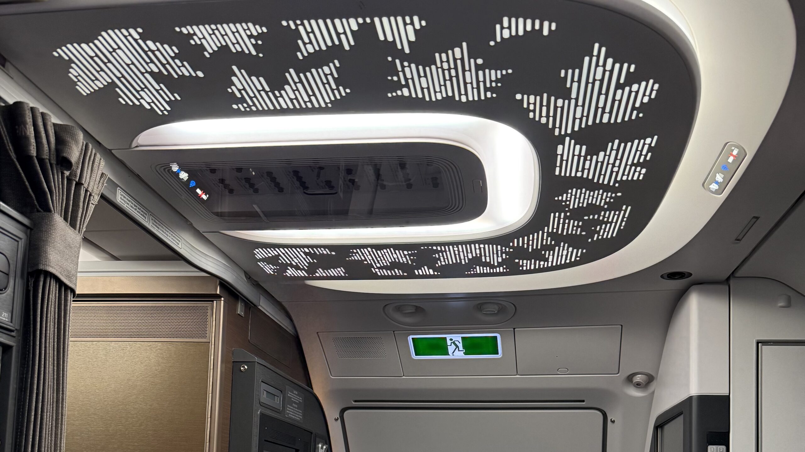 a ceiling with a light panel and a screen