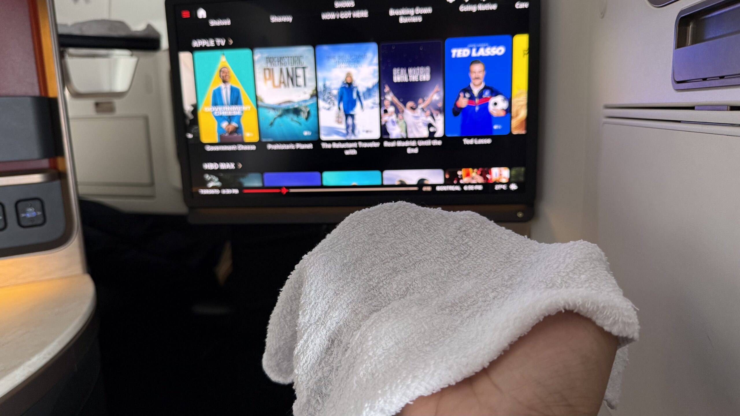 Inaugural Air Canada A321XLR a hand with a towel on a television screen