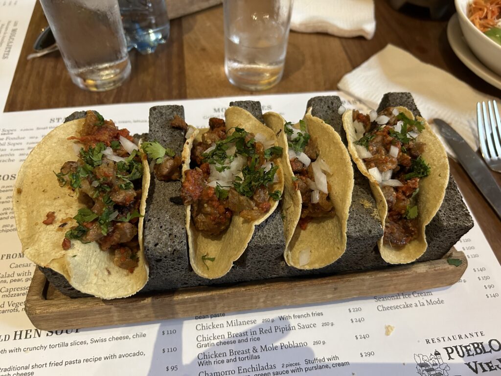 a group of tacos on a stone block