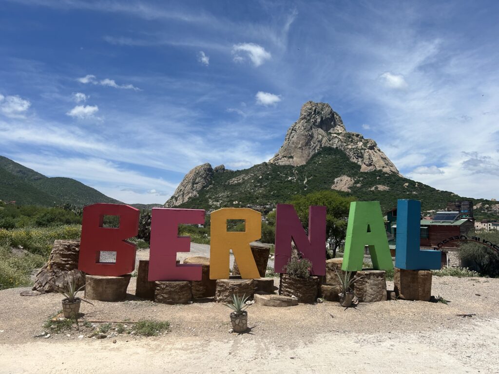 a colorful sign in front of a mountain