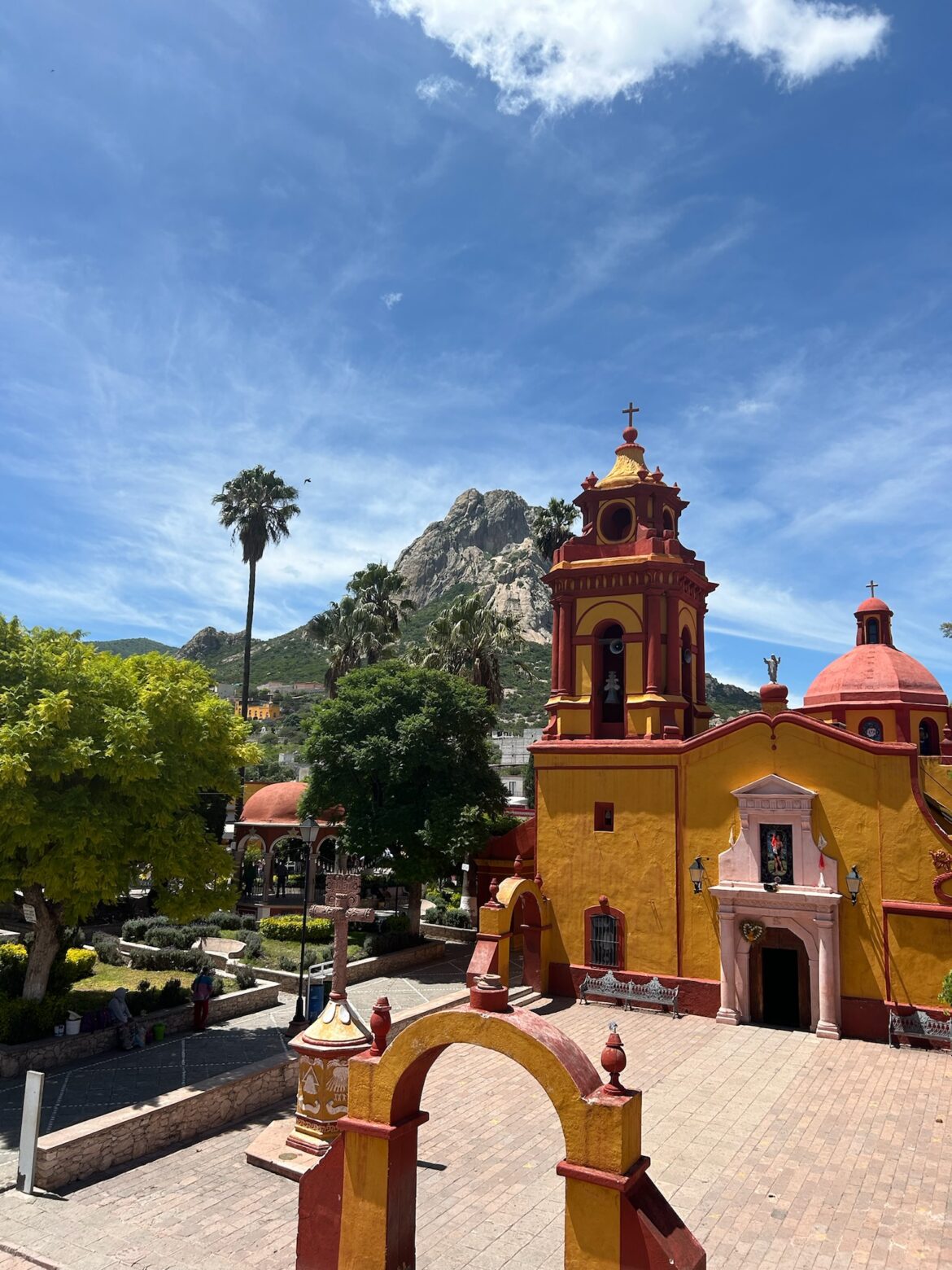 a yellow and red church with a large tower