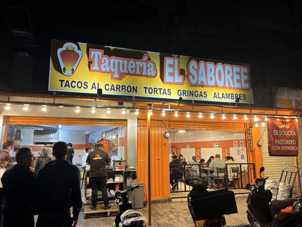 a building with a sign and people outside
