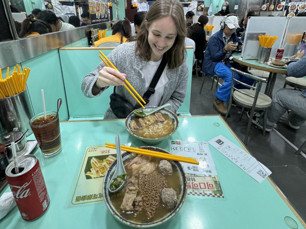 a woman eating food at a restaurant