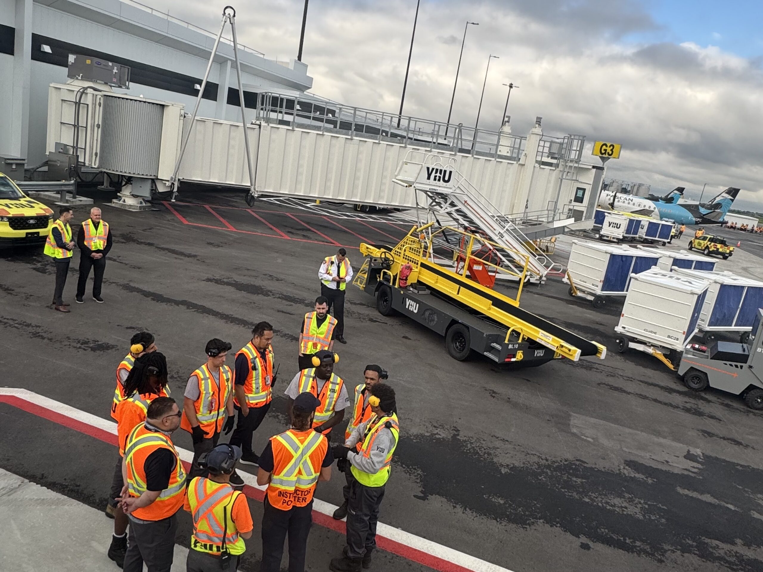 a group of people in vests standing around a vehicle