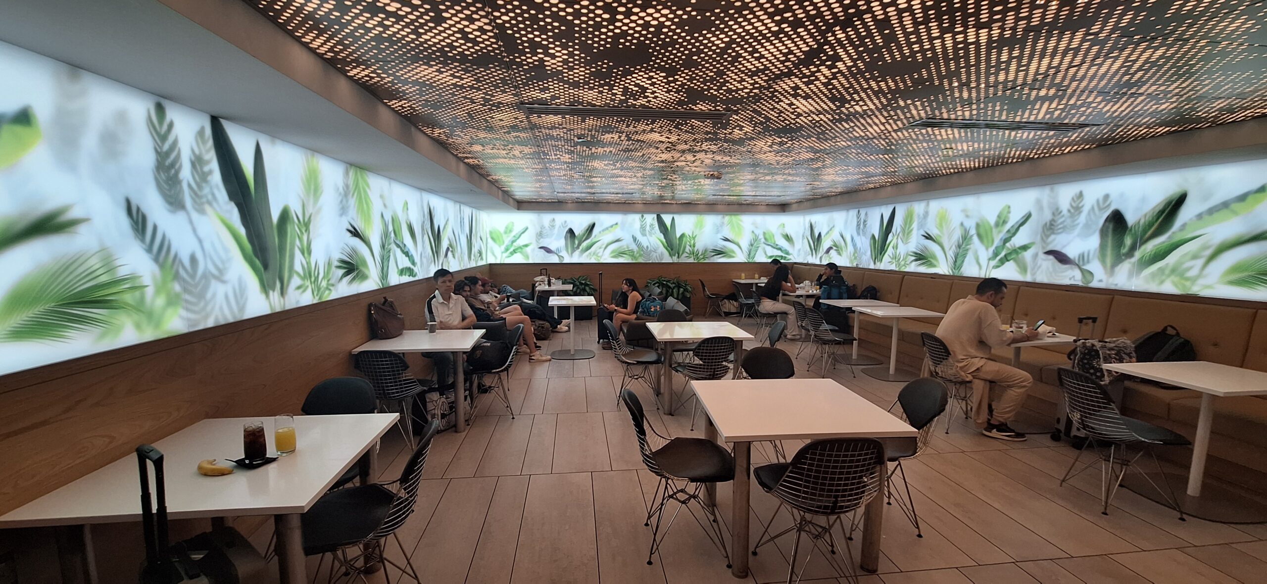 a group of people sitting at tables in a restaurant