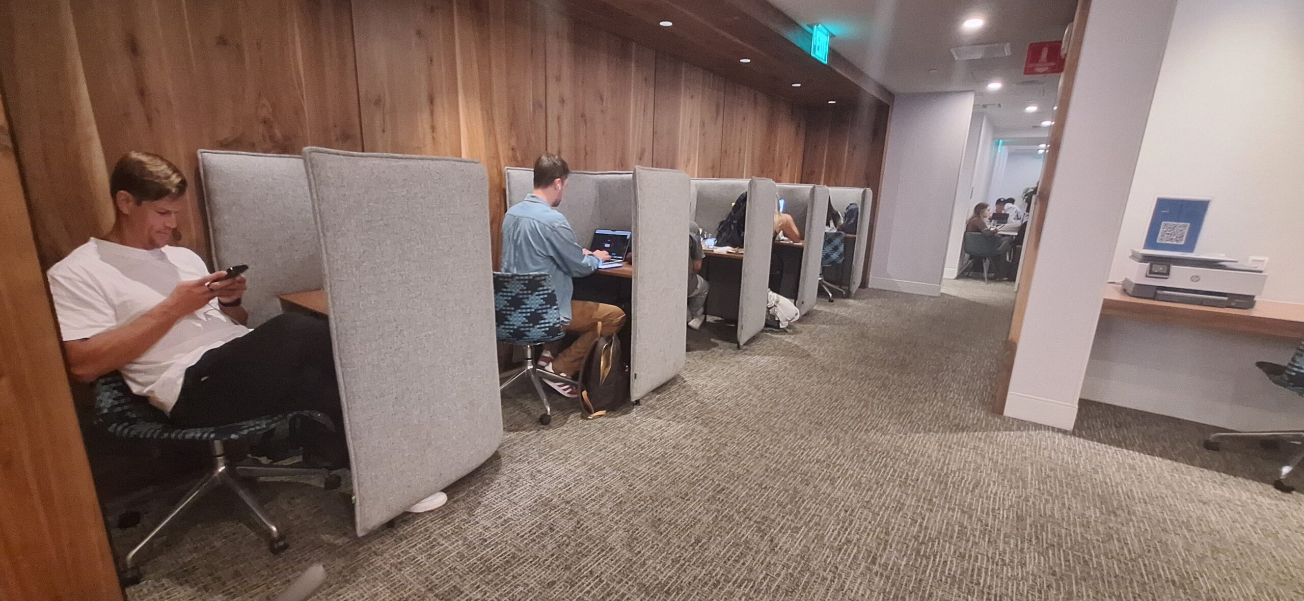 people sitting at a desk with a laptop