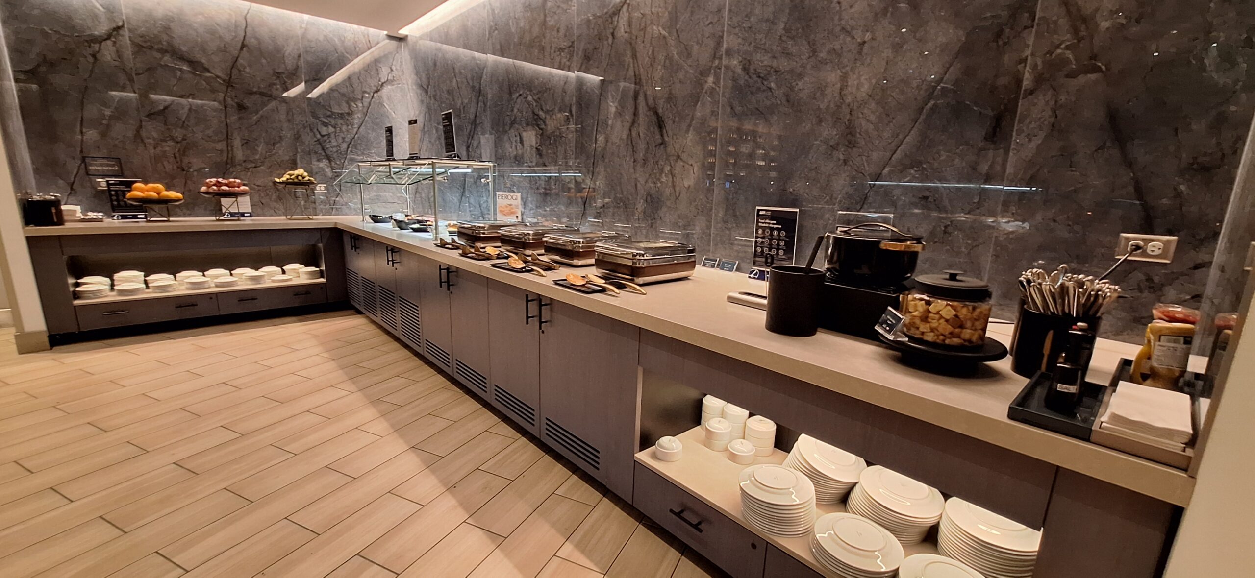 LOT Business Lounge ORD a buffet with plates and utensils