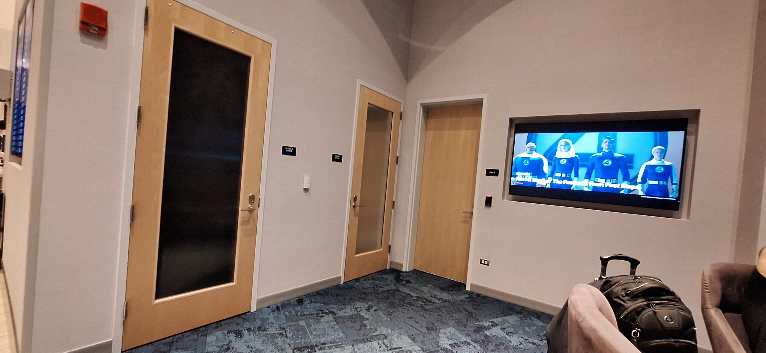 LOT Business Lounge ORD a room with doors and a television