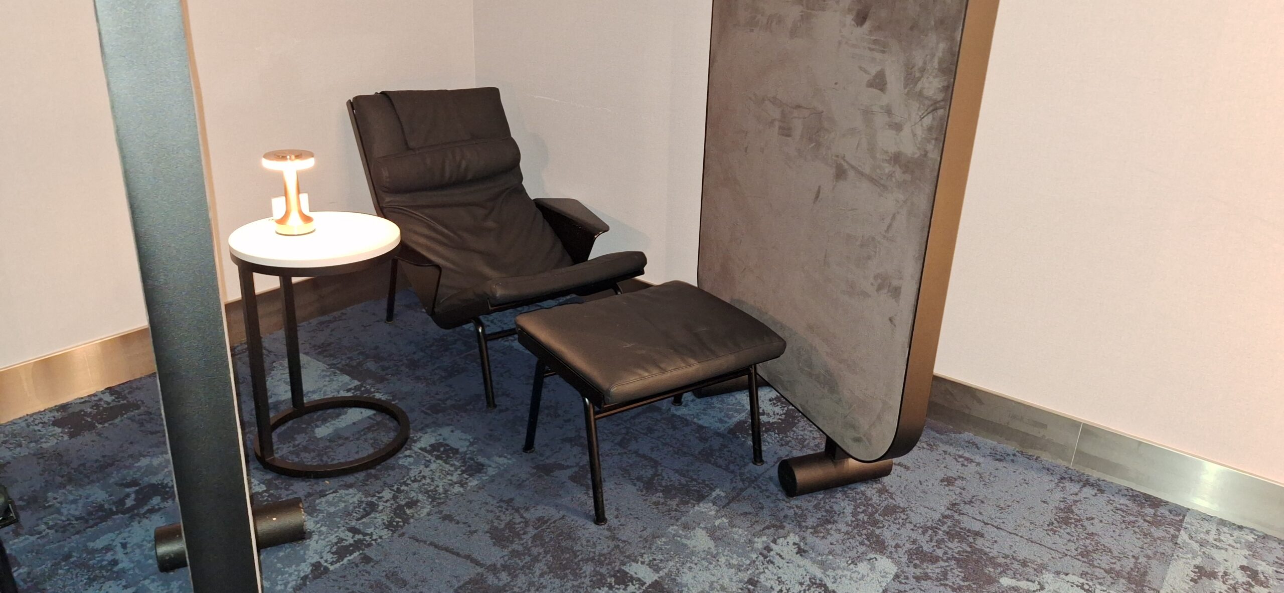 LOT Business Lounge ORD a chair and a table in a room