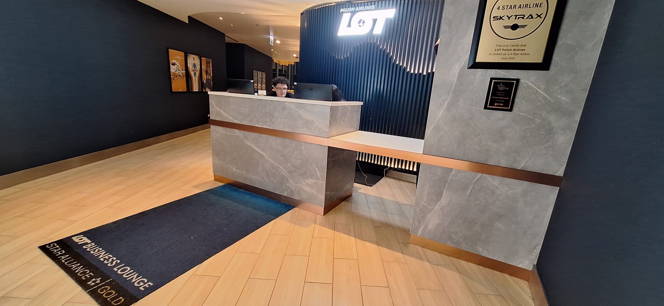 LOT Business Lounge ORD a man sitting at a desk