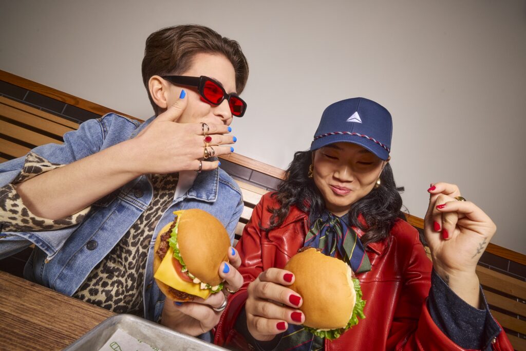 a man and woman eating burgers